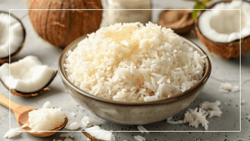a bowl of cooked coconut oil rice surrounded by coconuts